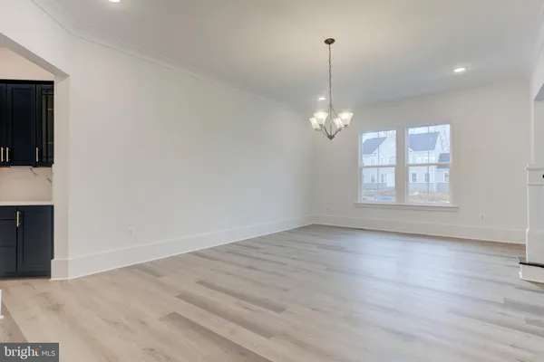an empty room with wooden floor and a window