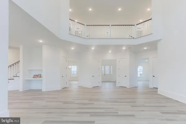 an empty room with wooden floor and window