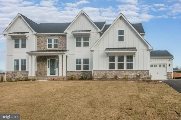 a front view of a house with a large space and a yard