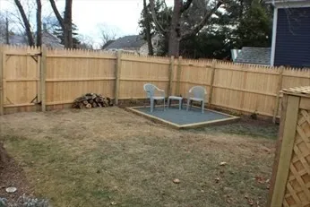 a backyard of a house with table and chairs