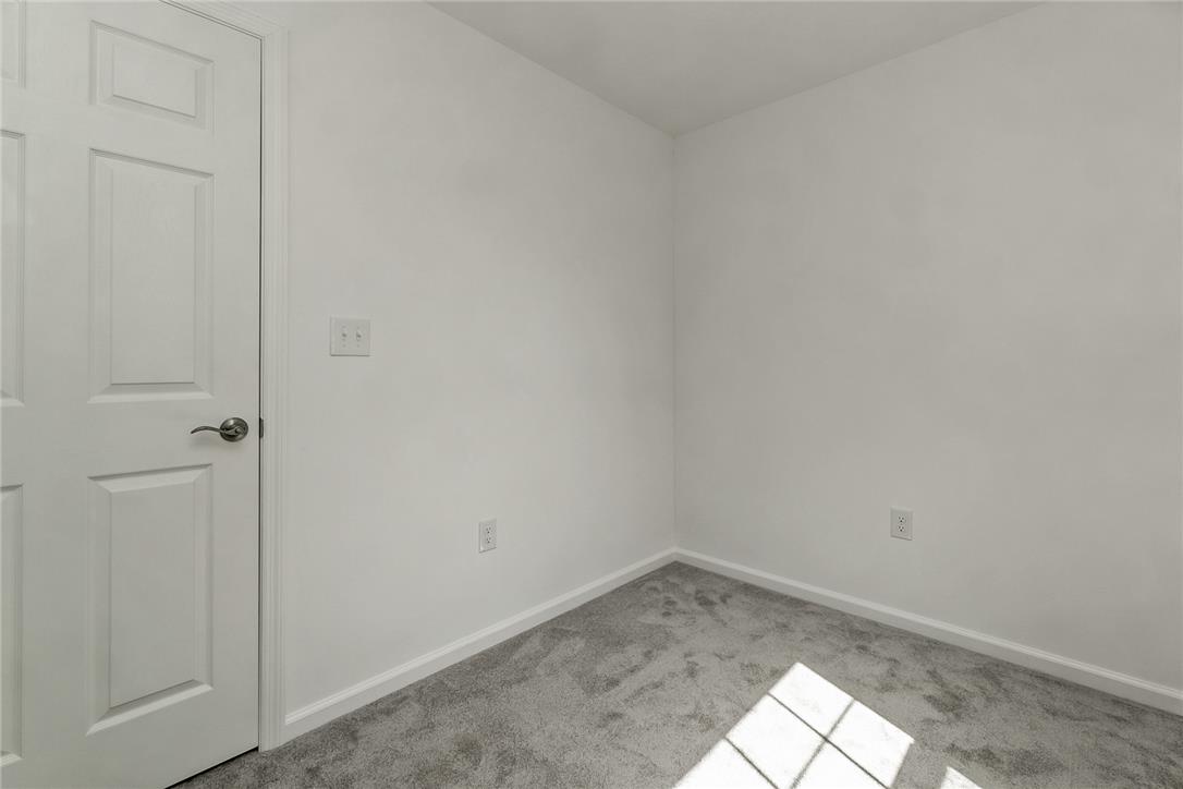624 Main Road Lehighton, PA 18235 - Photo 25 of 42 An inviting room awaits personalization, featuring a crisp white door and soft gray carpeting.