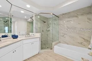 a bathroom with a double vanity sink mirror double and bathtub