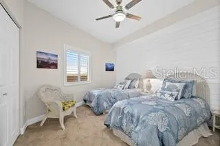a bedroom with two beds and painting on the wall