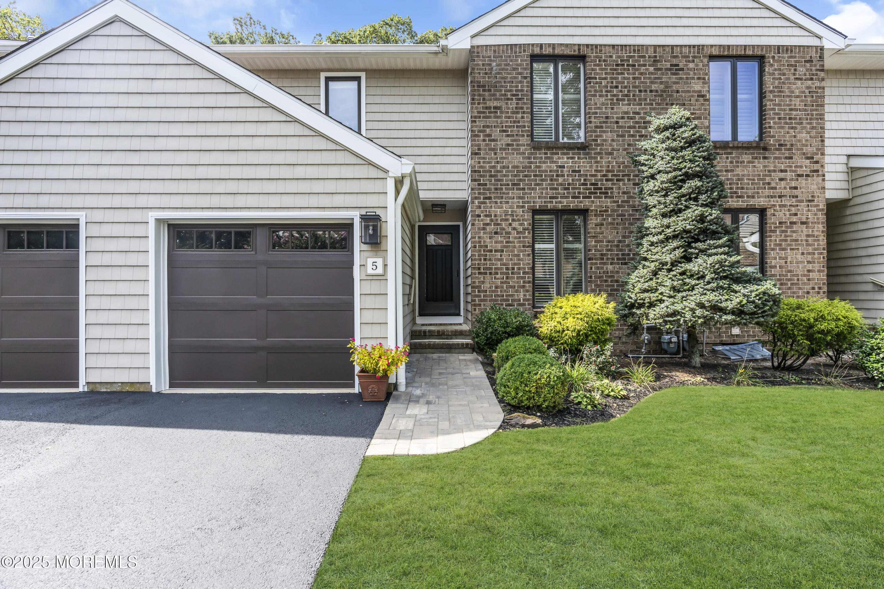 1301 Warren Avenue, Unit 5 Spring Lake, NJ 07762 - Photo 1 of 51 a front view of a house with a yard and garage