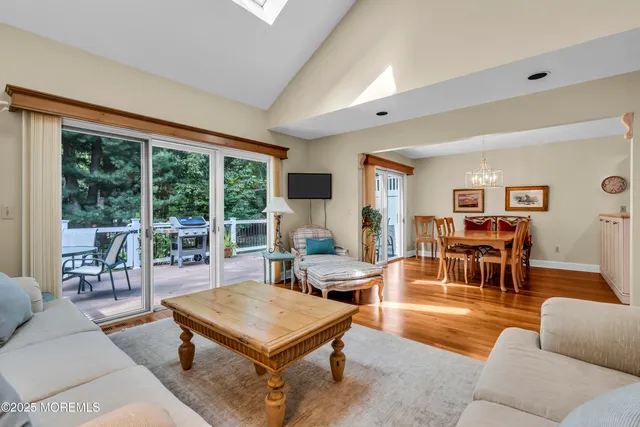 a living room with furniture a table and a large window