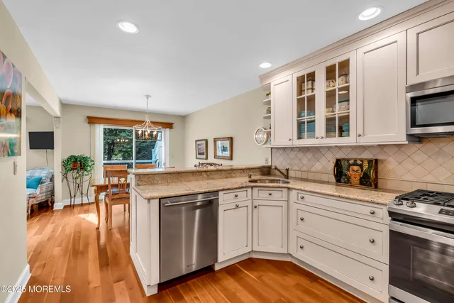 a kitchen with stainless steel appliances granite countertop a stove and cabinets