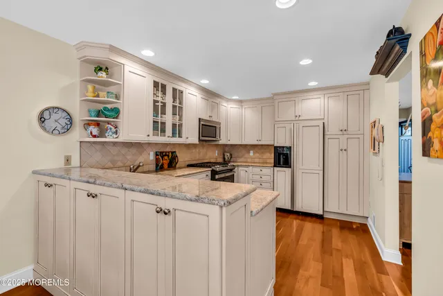 a kitchen with stainless steel appliances granite countertop a sink and cabinets