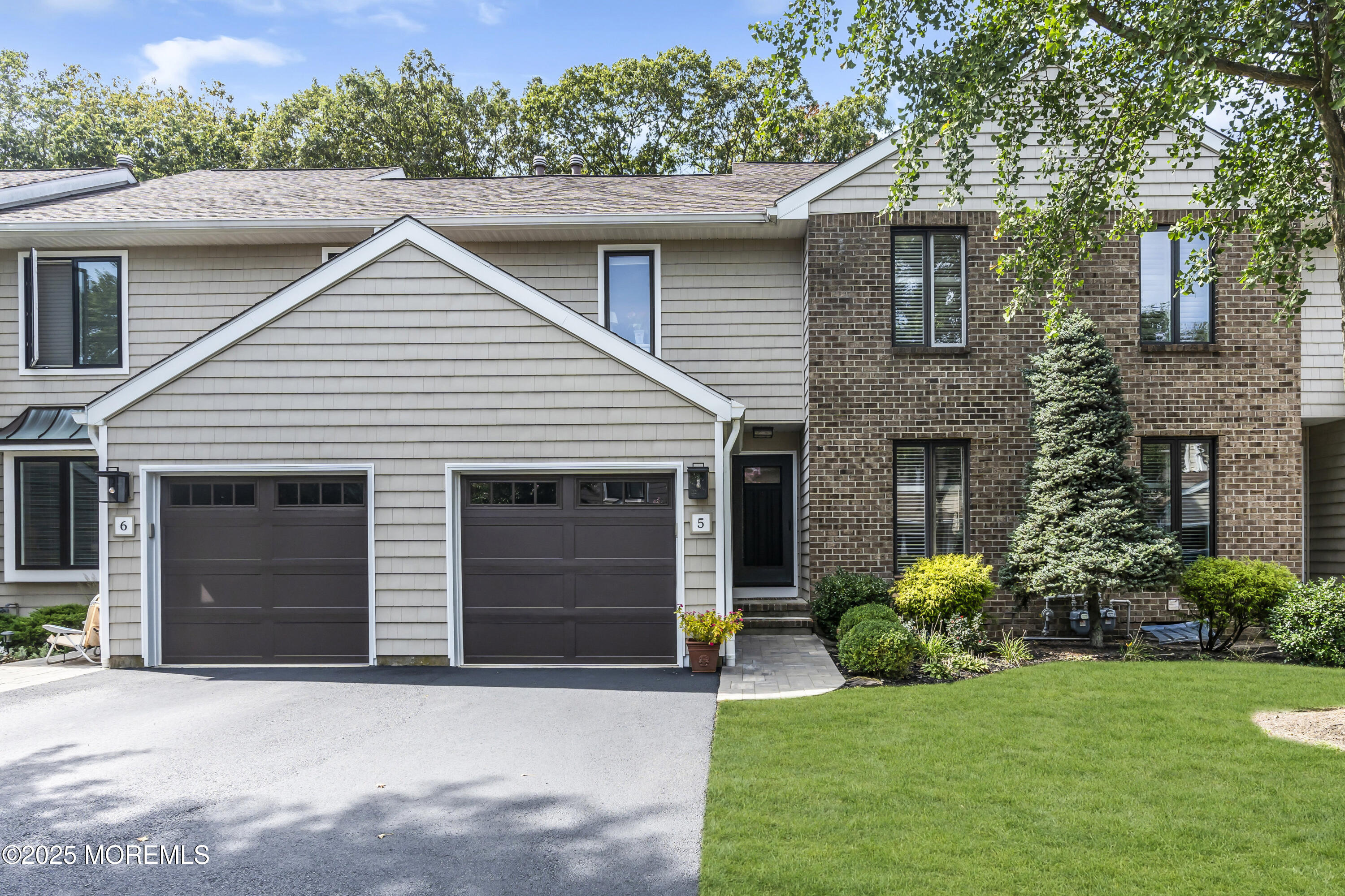 1301 Warren Avenue, Unit 5 Spring Lake, NJ 07762 - Photo 2 of 51 a front view of a house with a garden