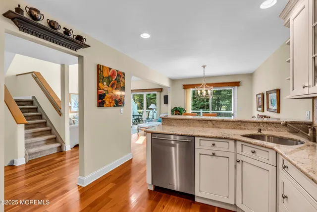 a kitchen with stainless steel appliances granite countertop a stove and a sink