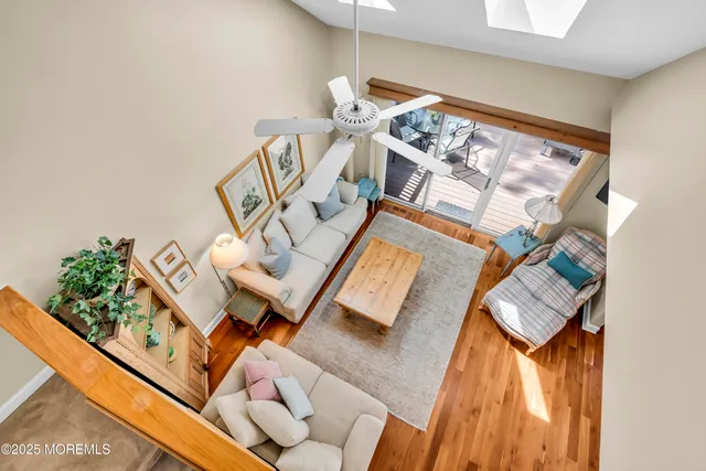view of a living room with a rug and a floor to ceiling window