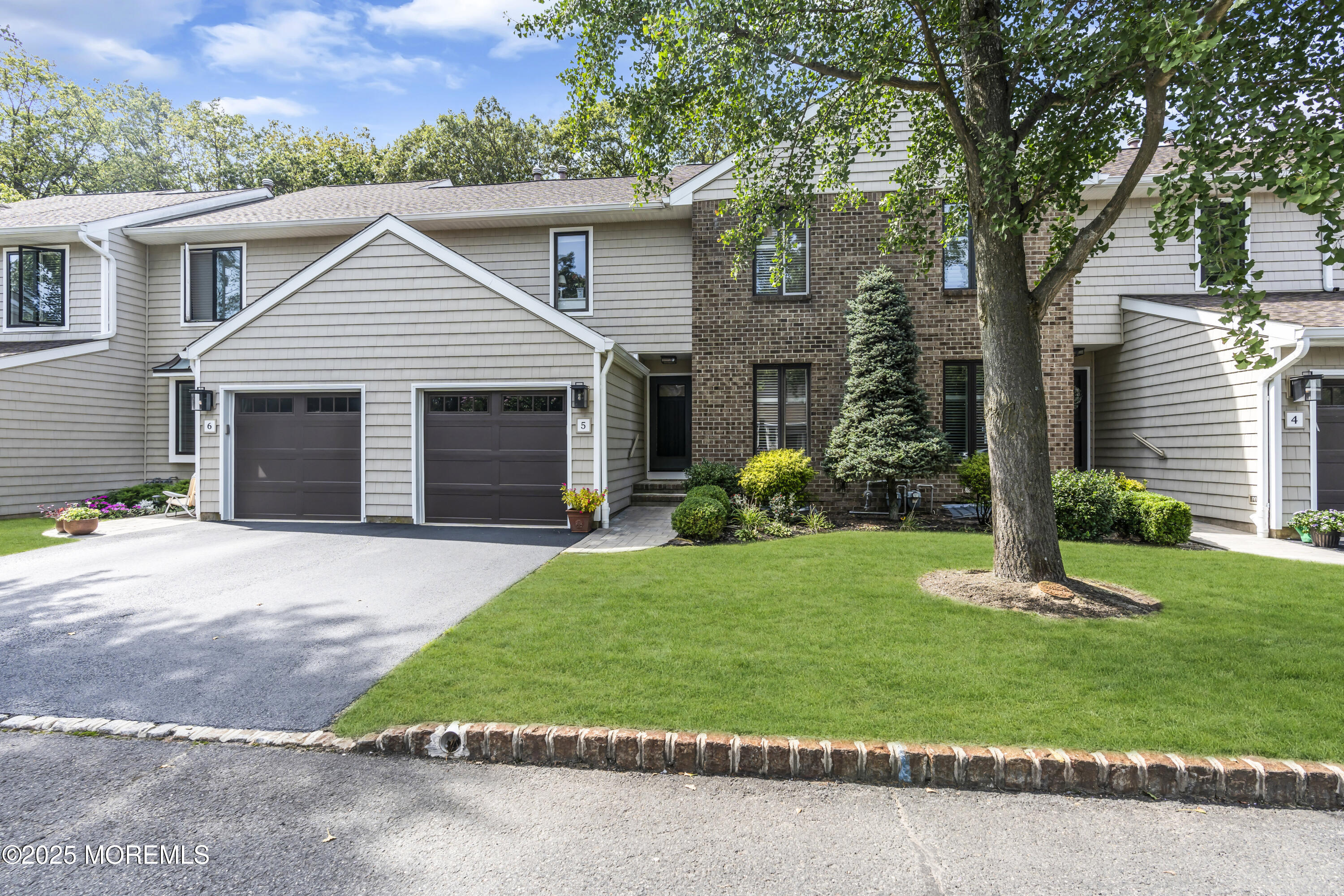 1301 Warren Avenue, Unit 5 Spring Lake, NJ 07762 - Photo 3 of 51 a front view of a house with a garden and plants