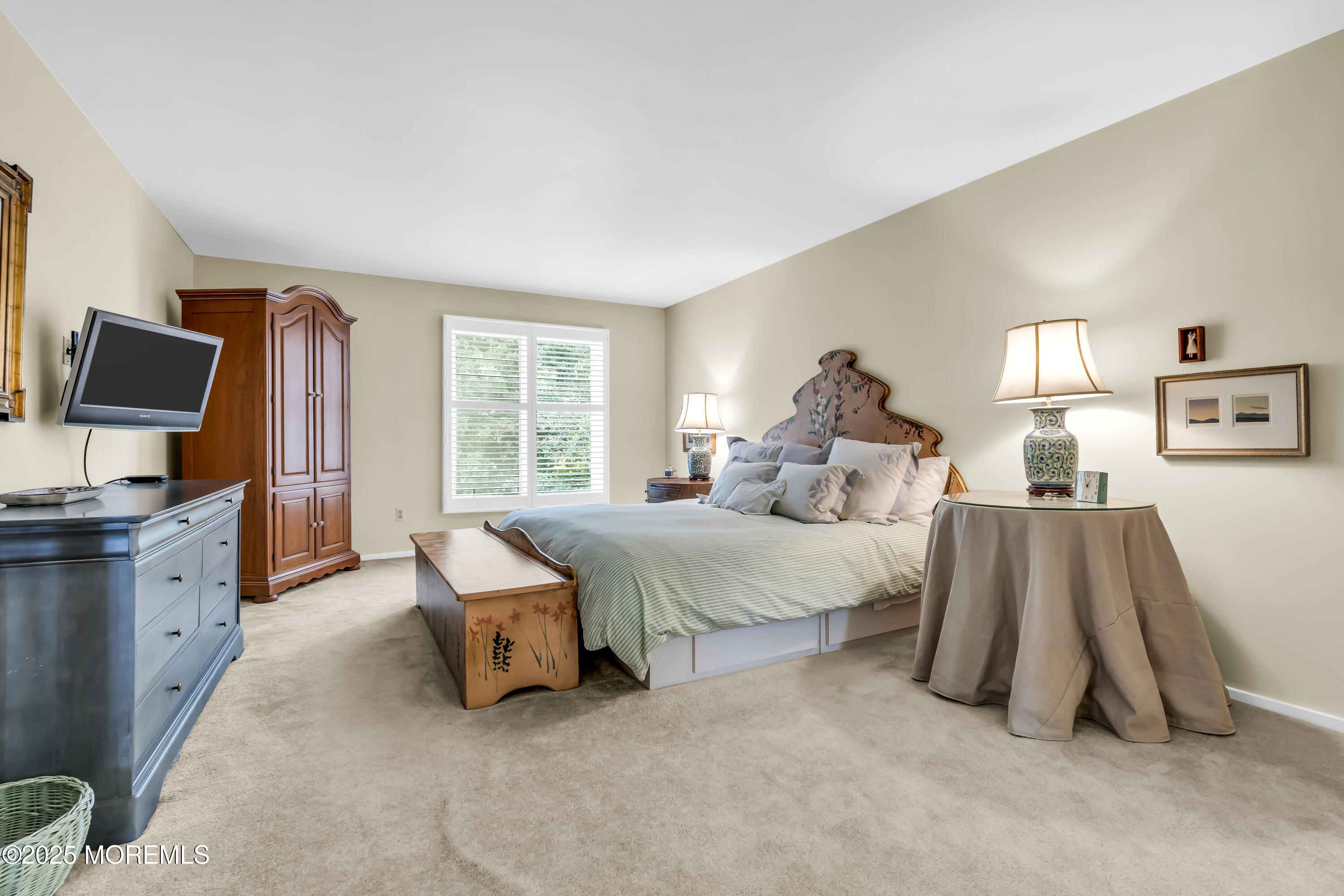 1301 Warren Avenue, Unit 5 Spring Lake, NJ 07762 - Photo 31 of 51 a spacious bedroom with a bed and a flat tv screen on dresser