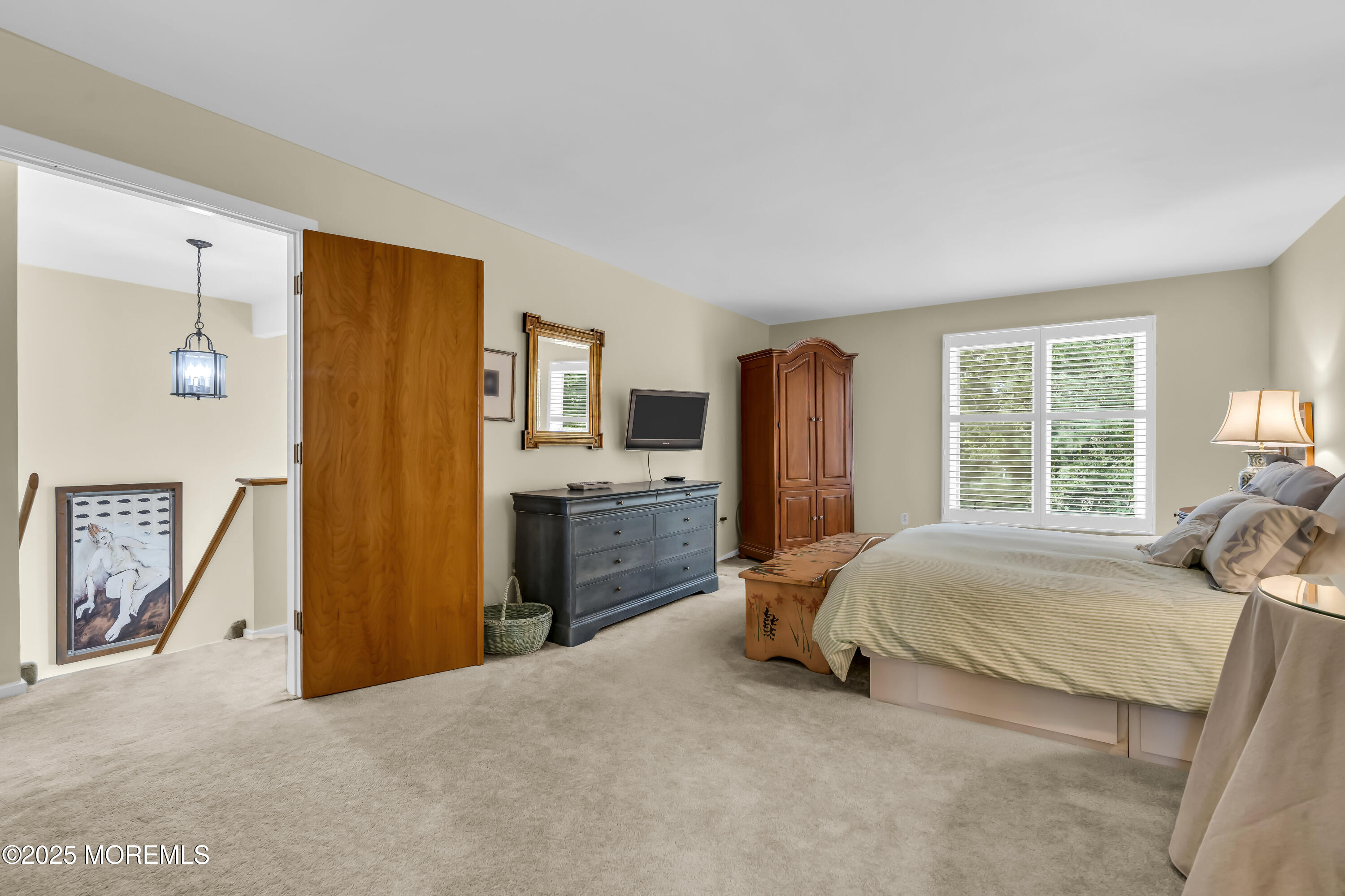 1301 Warren Avenue, Unit 5 Spring Lake, NJ 07762 - Photo 32 of 51 a bed room with a bed and a chair