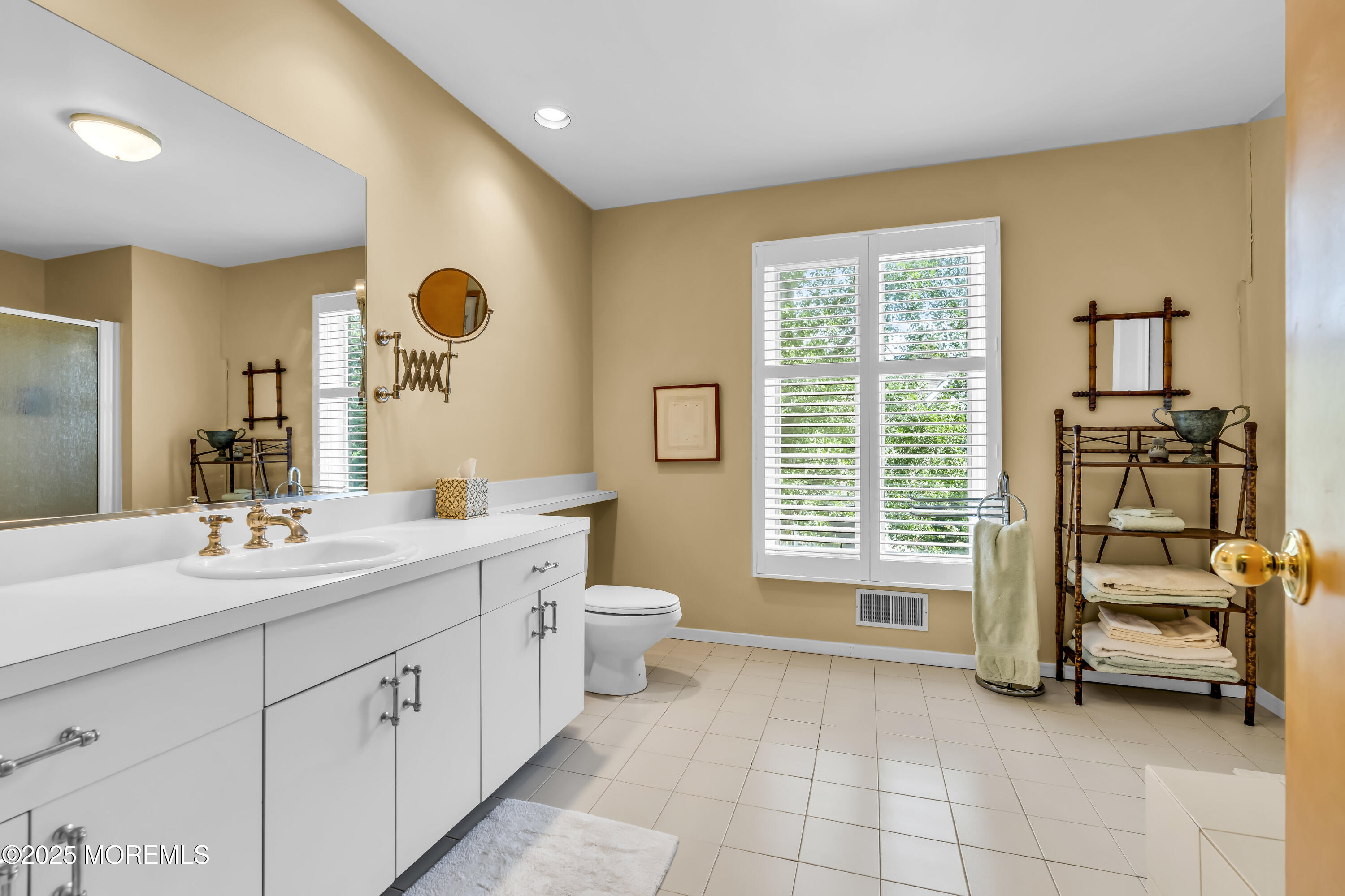 1301 Warren Avenue, Unit 5 Spring Lake, NJ 07762 - Photo 35 of 51 a spacious bathroom with a double vanity sink a mirror and a bathtub