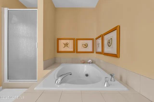 a bathroom with a tub and shower