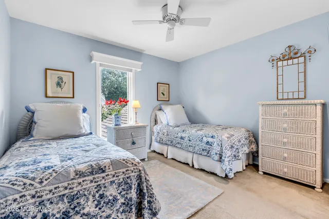 a bedroom with a bed a dresser and painting on the wall