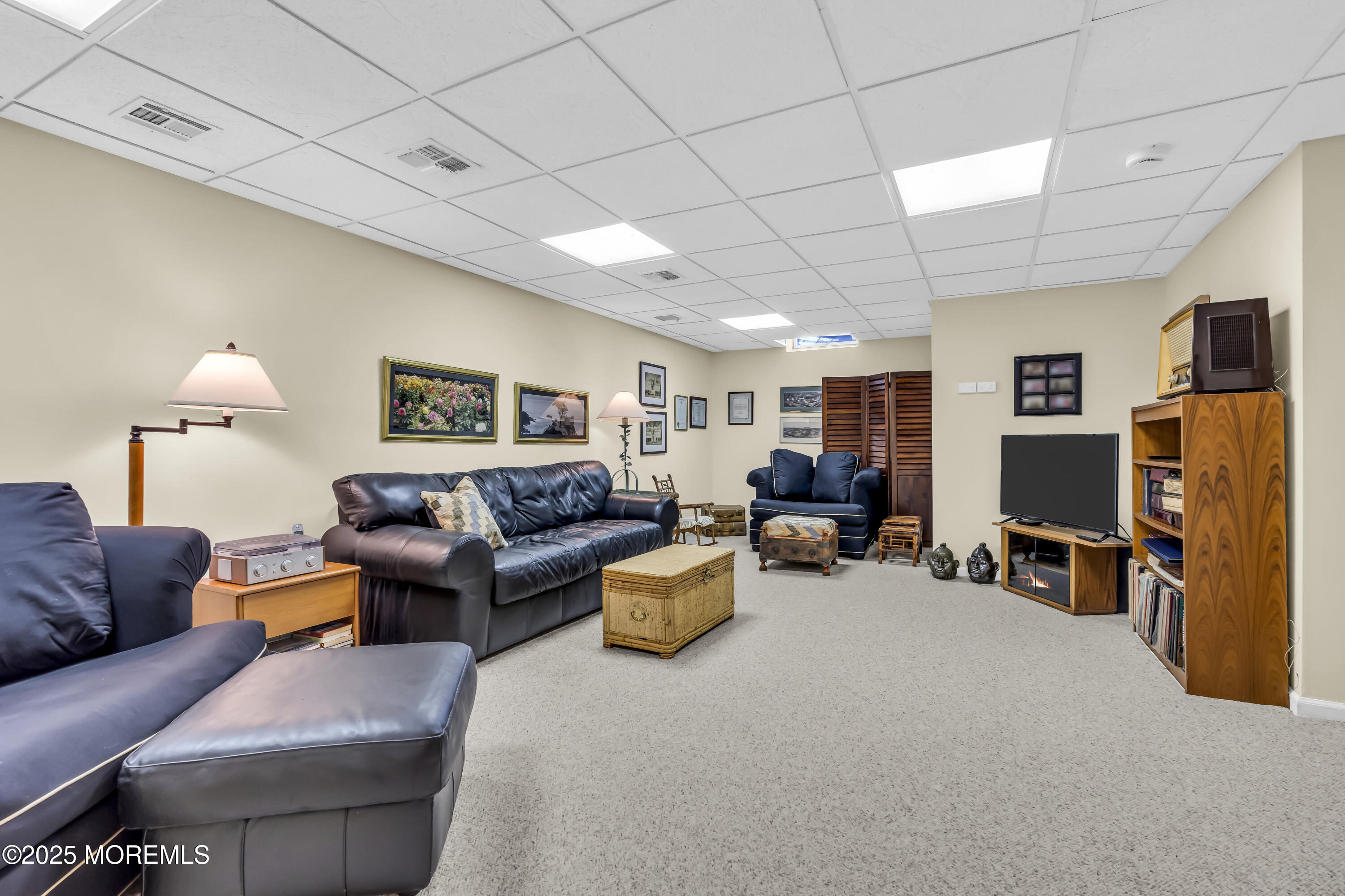 1301 Warren Avenue, Unit 5 Spring Lake, NJ 07762 - Photo 40 of 51 a living room with furniture and a flat screen tv