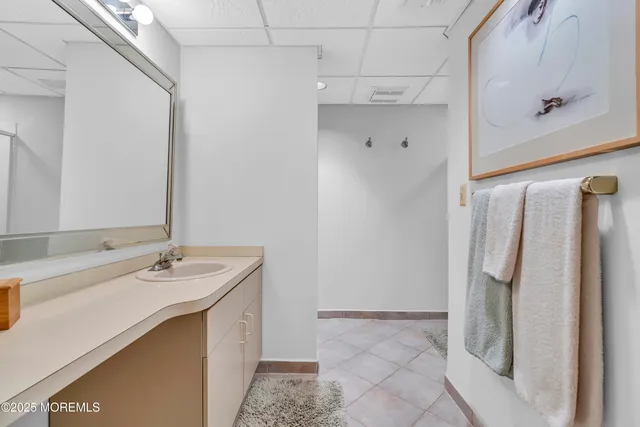 a bathroom with a sink vanity and a mirror