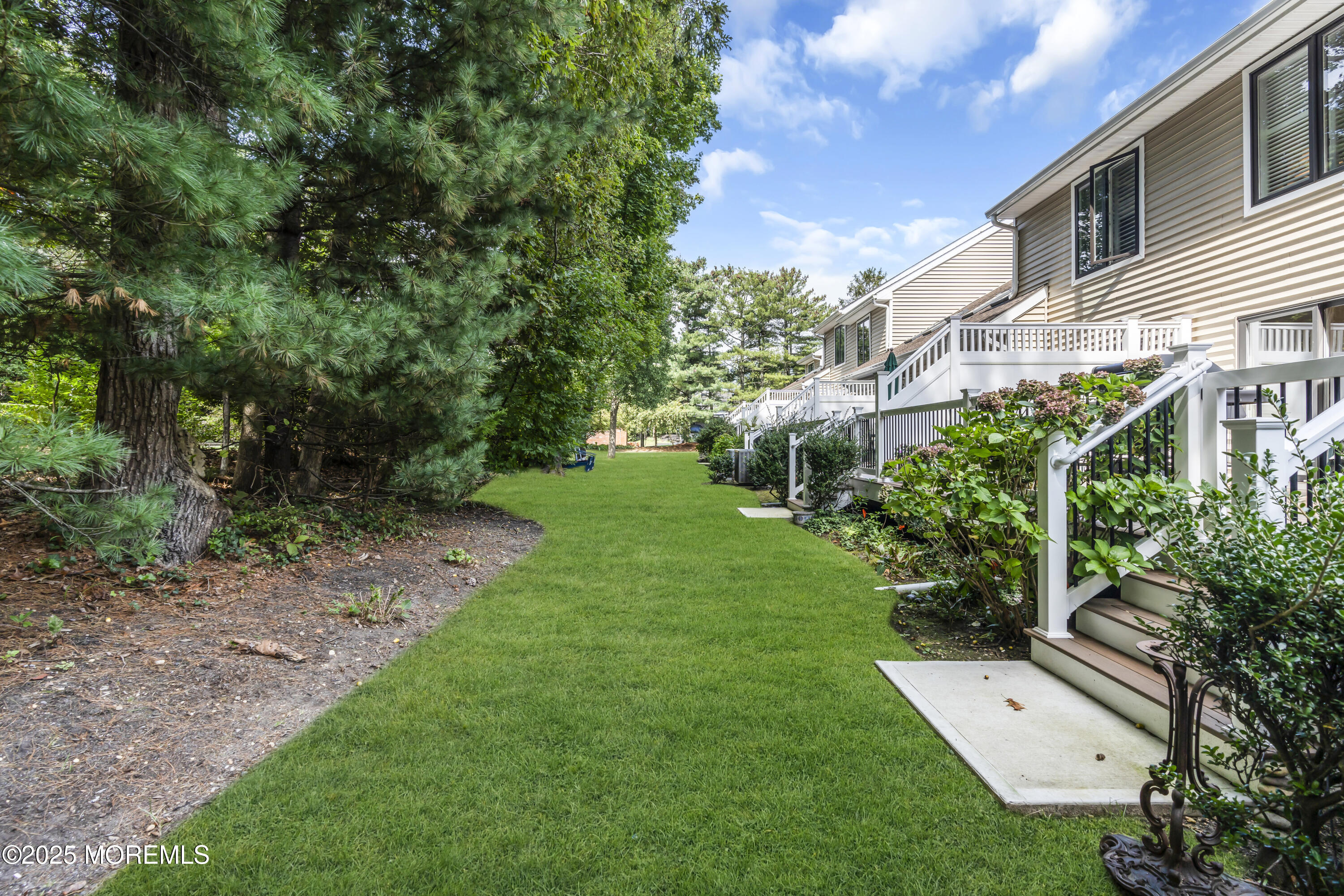 1301 Warren Avenue, Unit 5 Spring Lake, NJ 07762 - Photo 50 of 51 a view of a white house with a big yard plants and large trees
