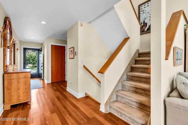 a view of entryway and hall with wooden floor