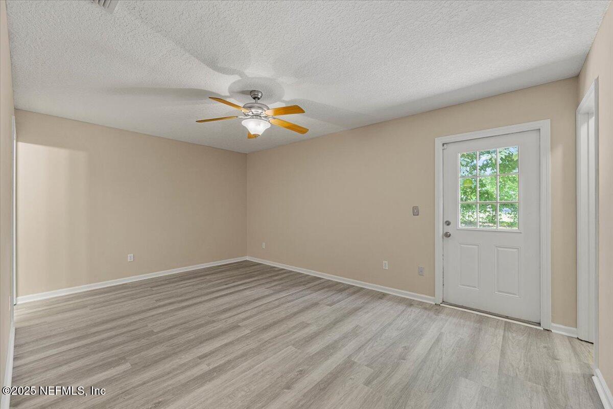 4527 Clairmont Road Jacksonville, FL 32207 - Photo 13 of 31 an empty room with wooden floor and window