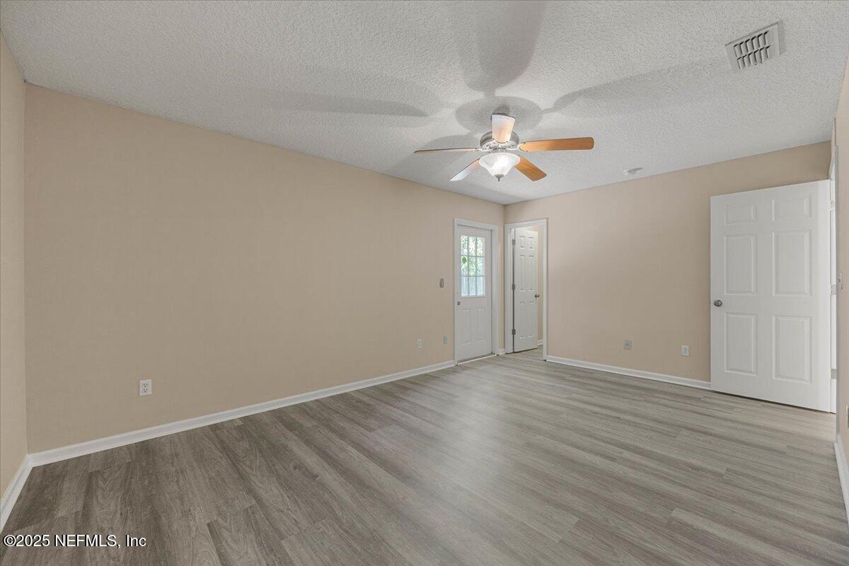 4527 Clairmont Road Jacksonville, FL 32207 - Photo 16 of 31 wooden floor in an empty room with a window