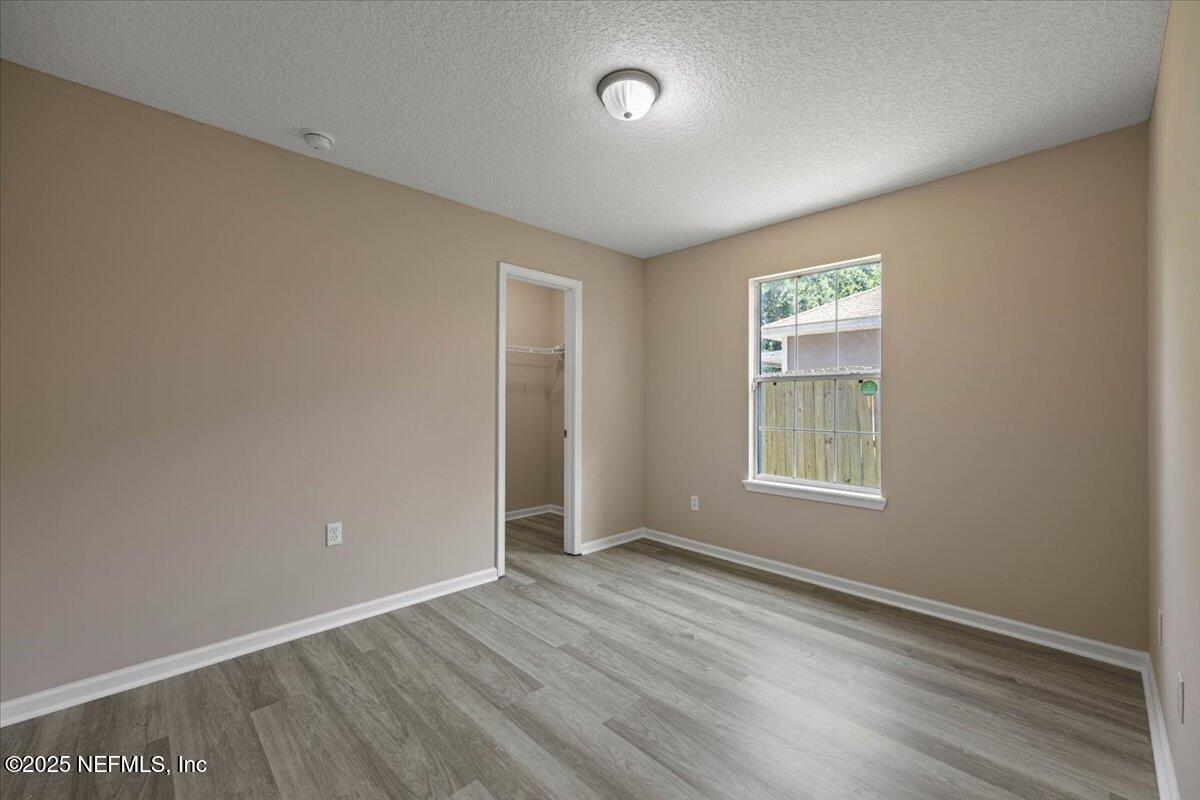 4527 Clairmont Road Jacksonville, FL 32207 - Photo 22 of 31 an empty room with wooden floor and windows