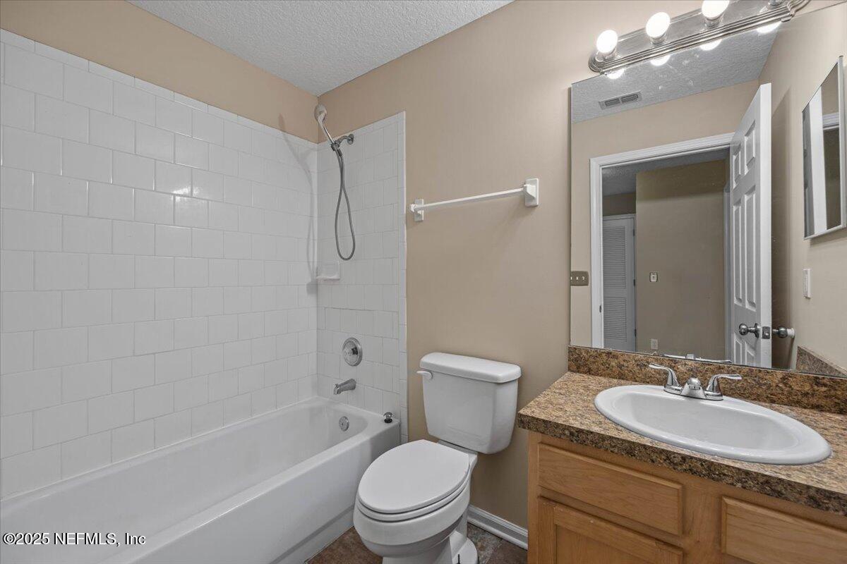 4527 Clairmont Road Jacksonville, FL 32207 - Photo 25 of 31 a bathroom with a sink toilet vanity and shower