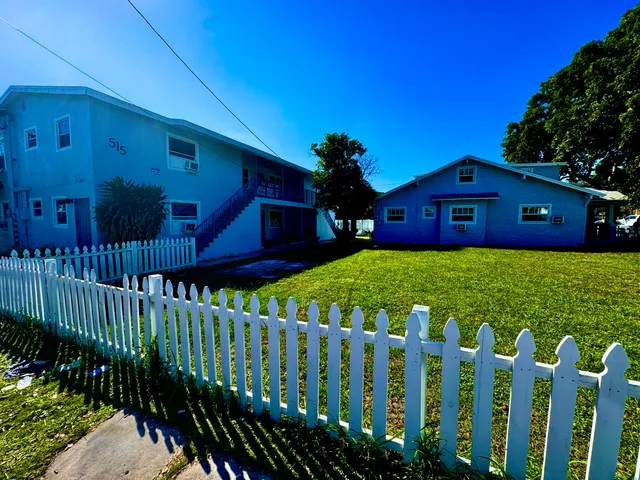 a view of a house with wooden fence