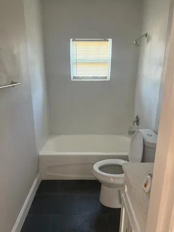 a bathroom with a toilet and a bathtub