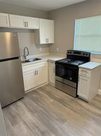 a kitchen with a stove and a sink