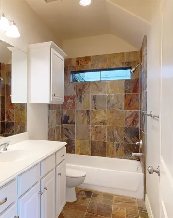 a bathroom with a sink toilet and shower