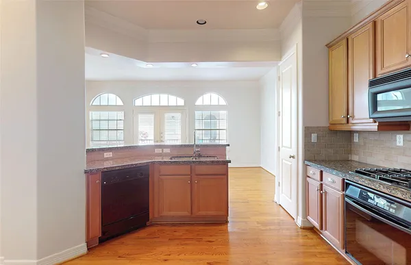 a large kitchen with a stove and a sink