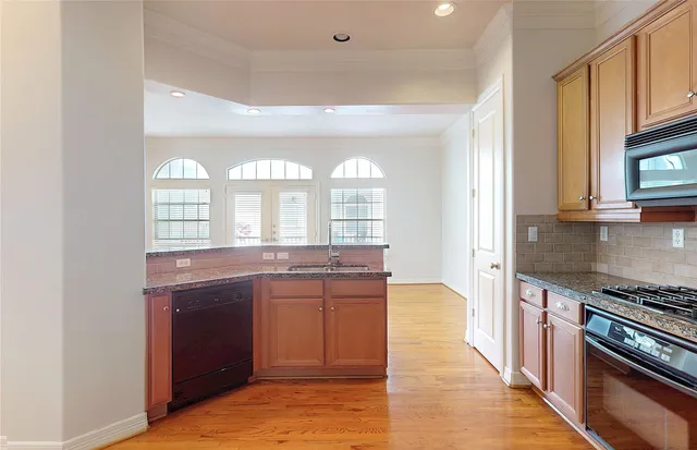 a large kitchen with a stove and a sink