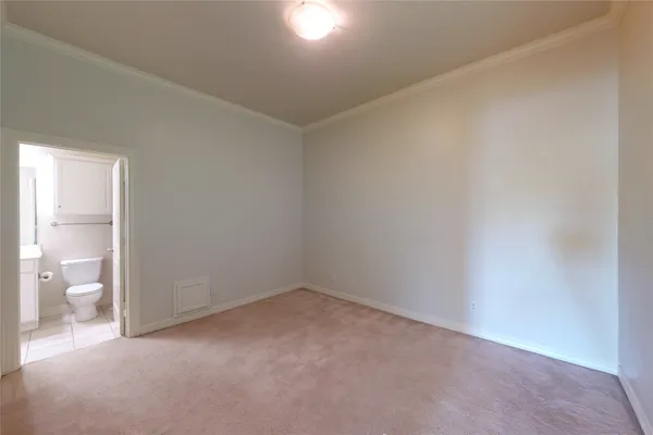 a view of an empty room and a bathroom