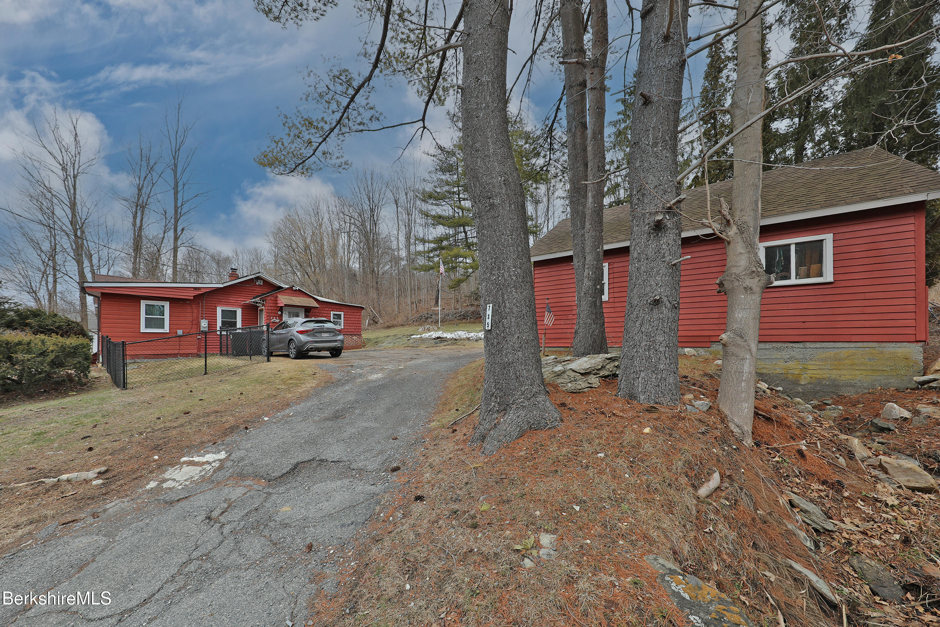 a view of a red house with a yard