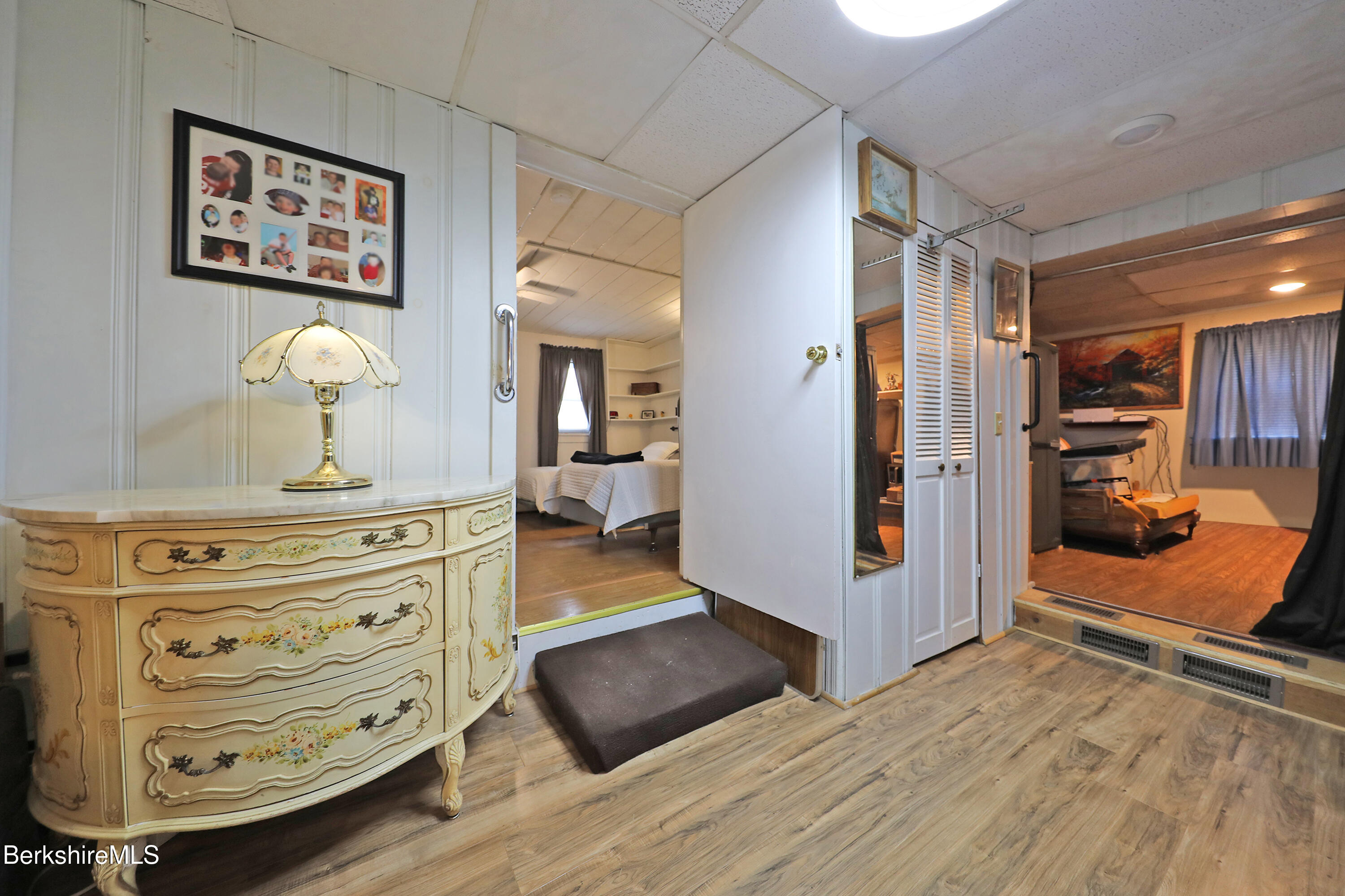 735 Cape Street Lee, MA 01238 - Photo 15 of 23 a view of a hallway with bedroom and a dresser