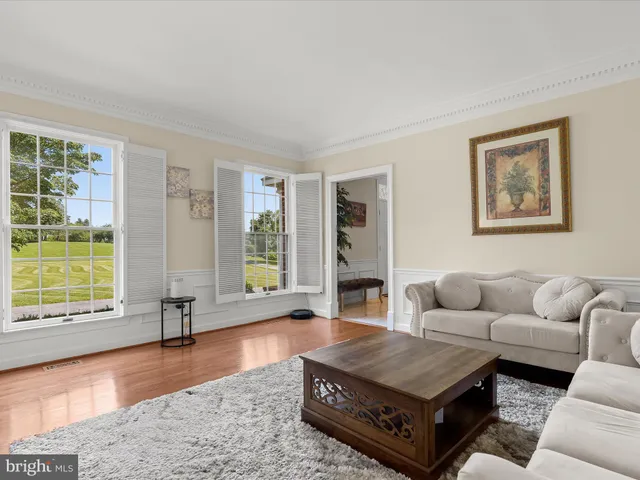 a view of a dining room with furniture large windows and wooden floor