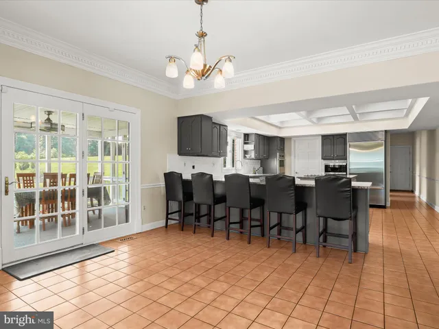 an empty room with wooden floor cabinet and windows