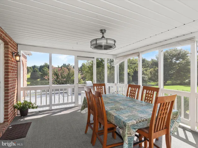 a bathroom with a tub a sink and a large mirror
