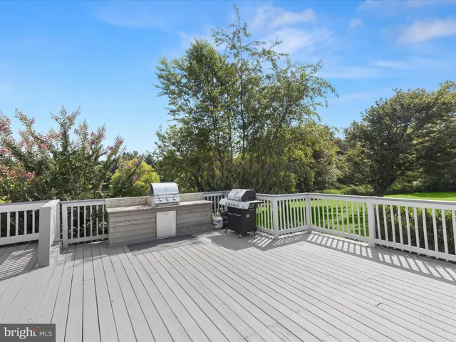 a spacious bedroom with a bed and a chandelier