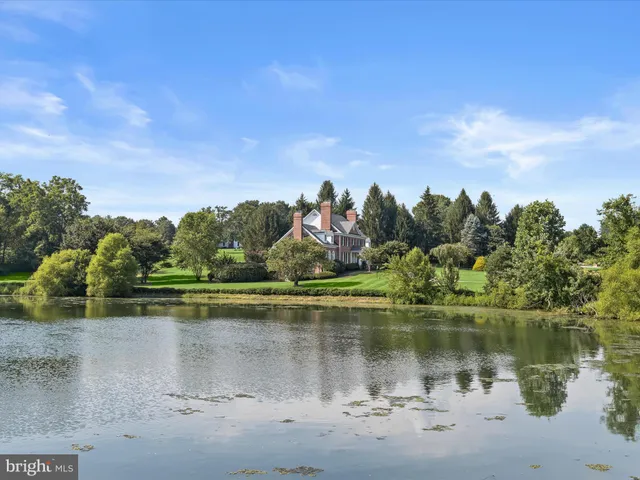 an aerial view of a house with swimming pool and garden