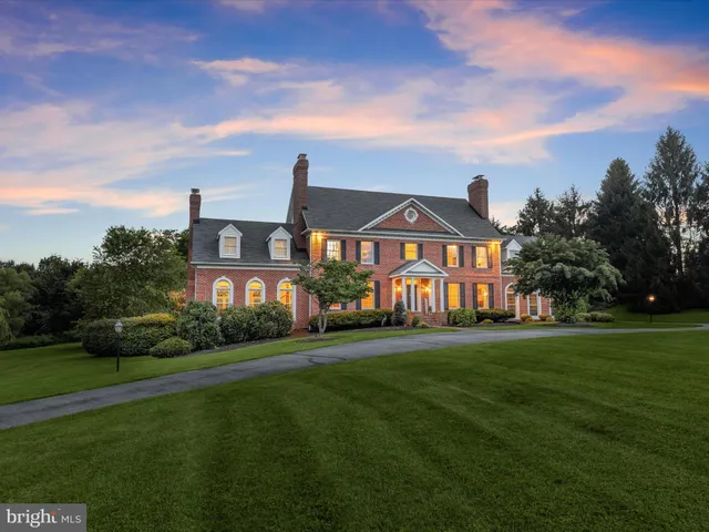 an aerial view of a house with a yard and lake view