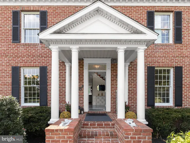 a view of a dining room with furniture a chandelier and wooden floor