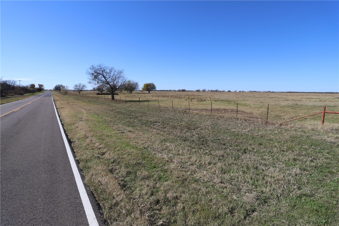 739 Willow Branch Road McGregor, TX 76657 - Photo 15 of 25 a view of a dry yard with wooden fence and trees