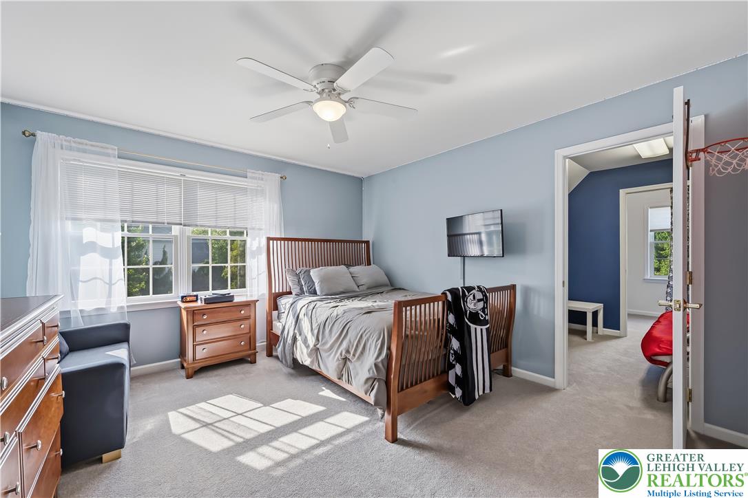 13 Country Road Northampton, PA 18067 - Photo 36 of 71 A comforting bedroom with a classic wooden bedframe features soft, sun-drenched carpeting and ample natural light.