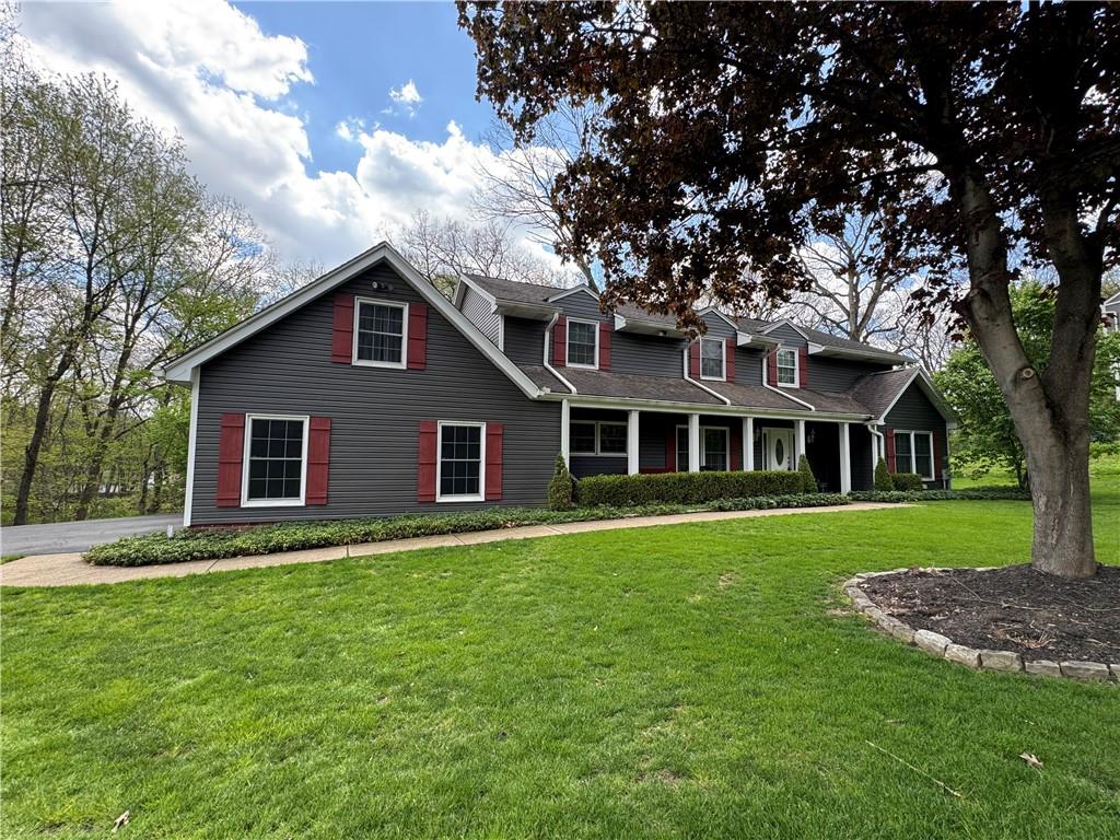 a front view of a house with a garden