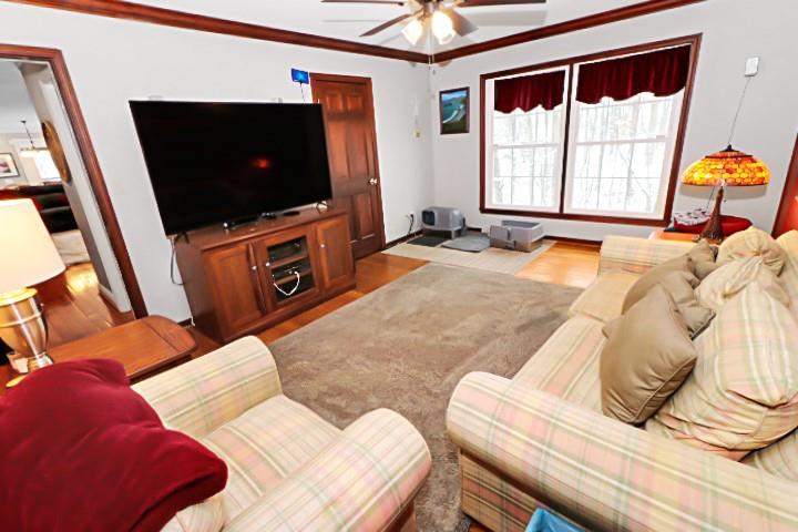 2776 Valleyview Drive Lower Burrell, PA 15068 - Photo 14 of 47 ceiling fan, wall to wall carpeting, and a wall of windows that overlook the back estate