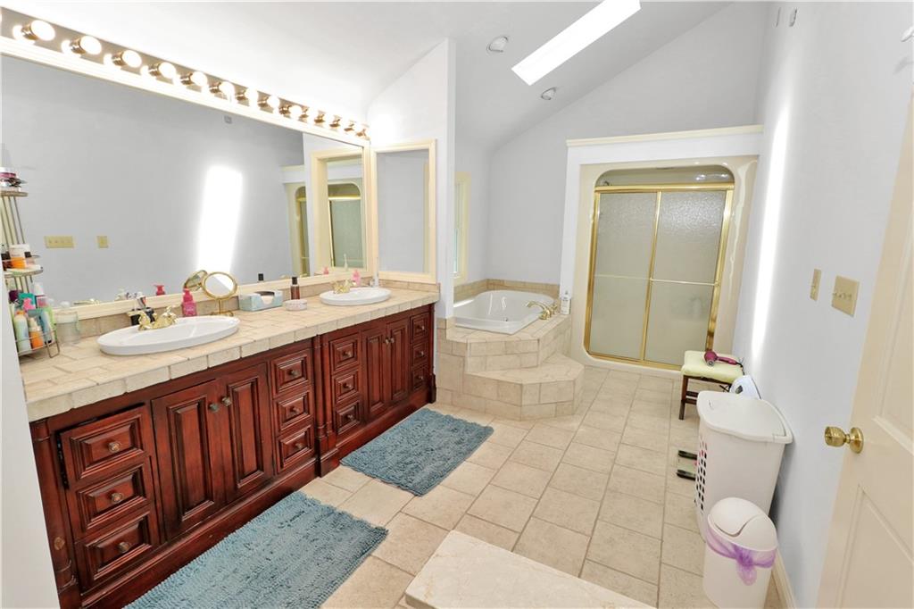 2776 Valleyview Drive Lower Burrell, PA 15068 - Photo 33 of 50 a spacious bathroom with a sink a mirror and a bathtub