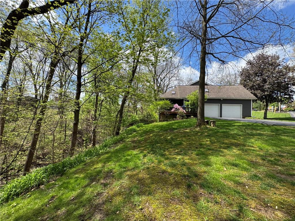 2776 Valleyview Drive Lower Burrell, PA 15068 - Photo 47 of 50 a front view of a house with a garden